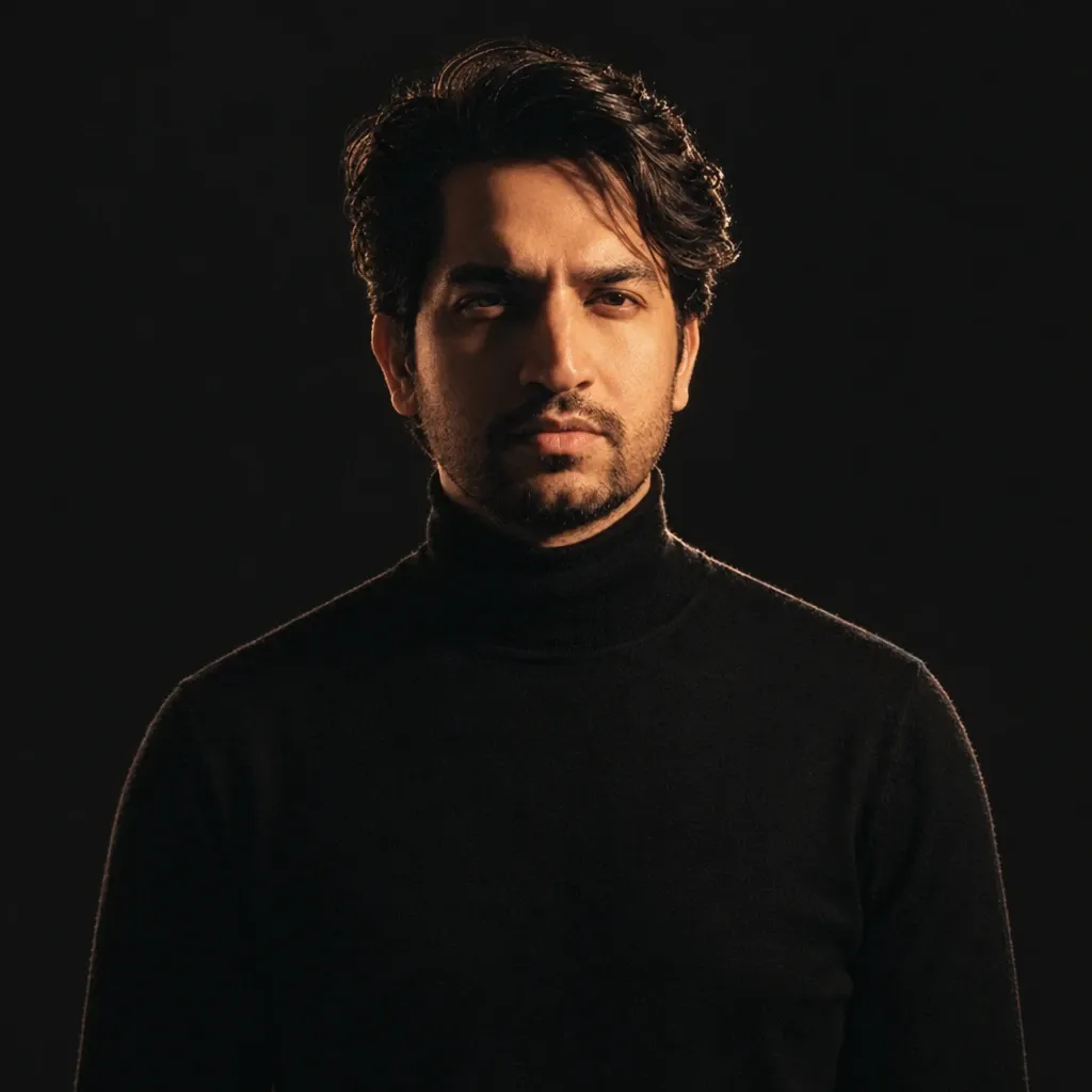 Aaliyaan Chaudhary, founder of Sixerr, in a black turtleneck, rim lit against a near-black background